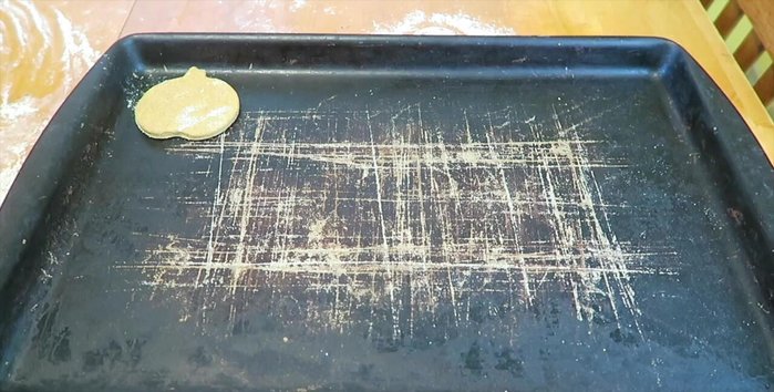 Place the pumpkin-shaped treats onto a cookie sheet.