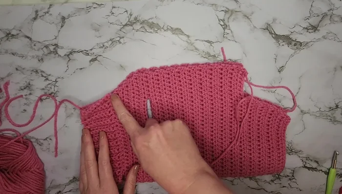 Single crochet along the open edge to stitch the sweater together. Fasten off and weave in the ends.