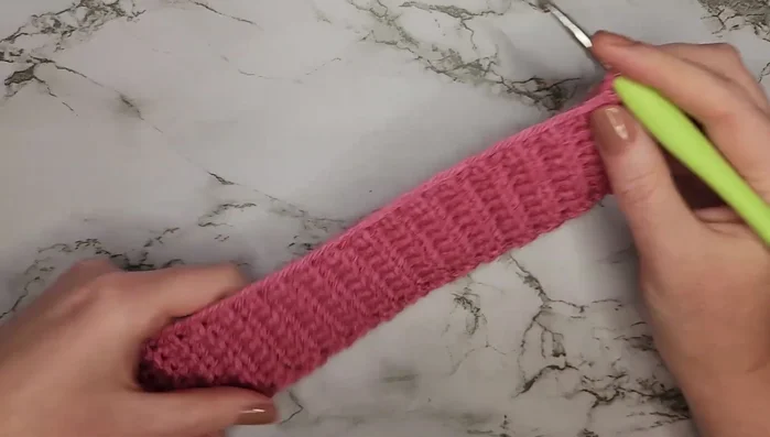 Chain eight for the dog lead loop, skip eight rows, single crochet into the next row (20 stitches total).