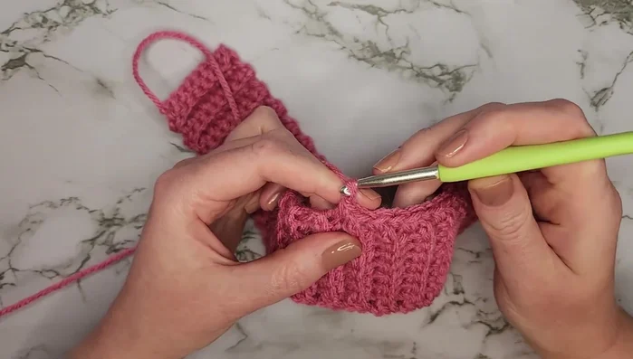 Chain eight for the dog lead loop, skip eight rows, single crochet into the next row (20 stitches total).