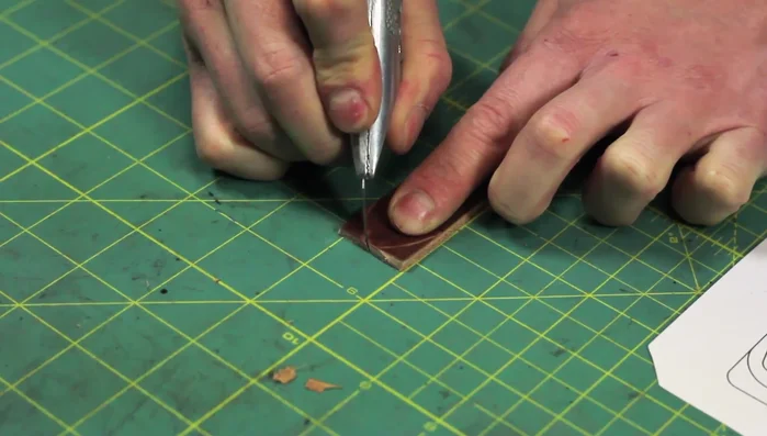 Punch out all the marked holes using a hole punch large enough for the rivets.