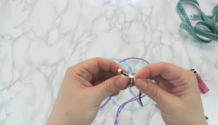 Tape the buckle to a surface, ensuring equal distance between male and female parts to match the desired collar size.