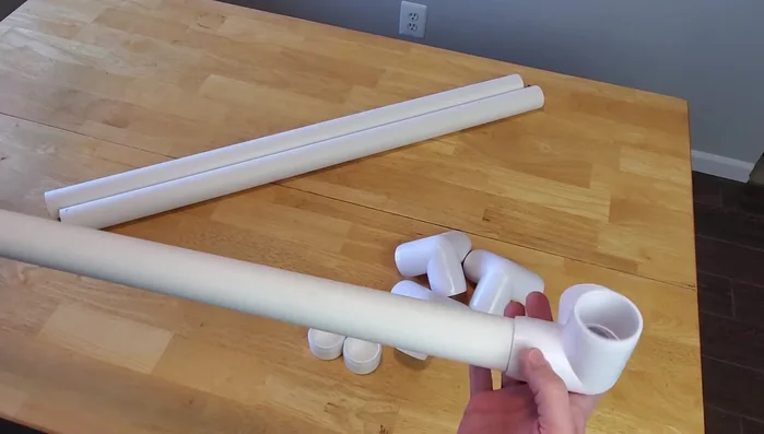 Assemble the PVC frame: Connect the pipes and fittings to form a rectangle, ensuring the short ends are opposite each other. Attach the four legs (4-inch PVC segments) using the flat end caps.