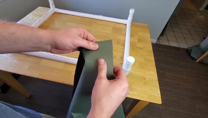 Prepare the fabric: Lay the 42x32 inch fabric rectangle upside down. Center the upside-down frame on the fabric.