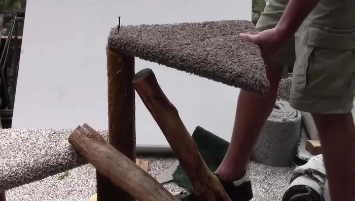 Attach the round bed to the cat tree using screws.