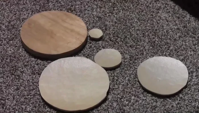 Glue the carpet padding circles onto the platform supports to create mushroom shapes.