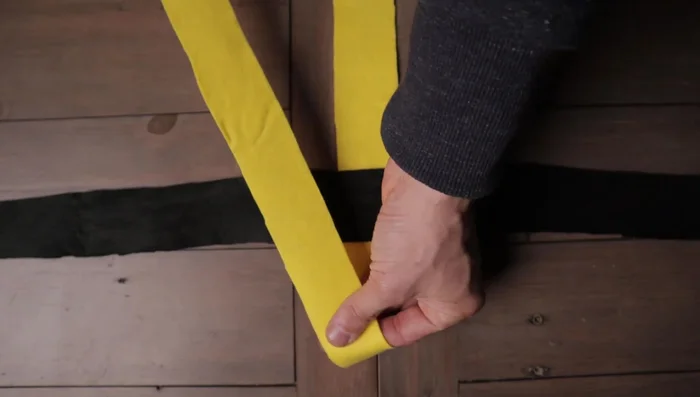 Tuck the final strip underneath the first strip through the hole created. Gently pull each side to tighten.