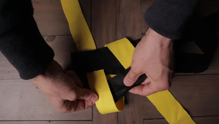 Tuck the final strip underneath the first strip through the hole created. Gently pull each side to tighten.