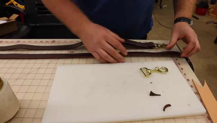 Create the traffic handle by folding the leather to form a loop. Ensure the leather butts up against the swivel snap for a secure fit. Rivet the handle to secure it in place.