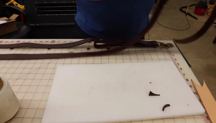 Align the handle with the main leash and fold the leather over the handle. Punch holes through the three layers (leash and handle) to accommodate the rivets.