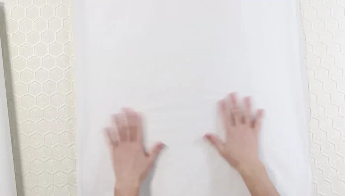 Use pins to transfer seam markings from the sweater to the paper.