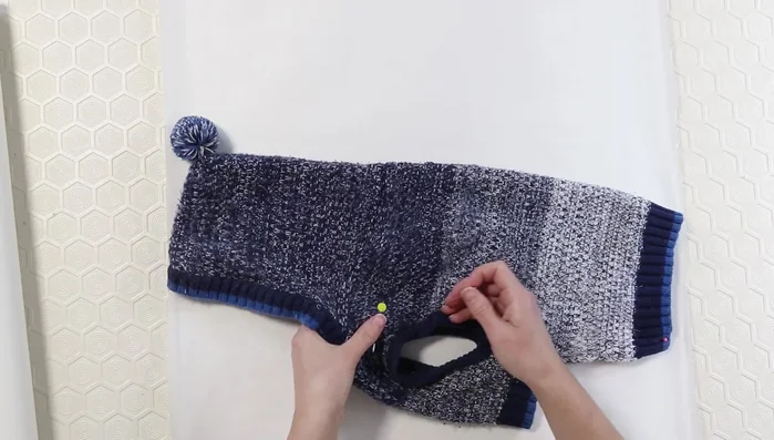 Use pins to transfer seam markings from the sweater to the paper.