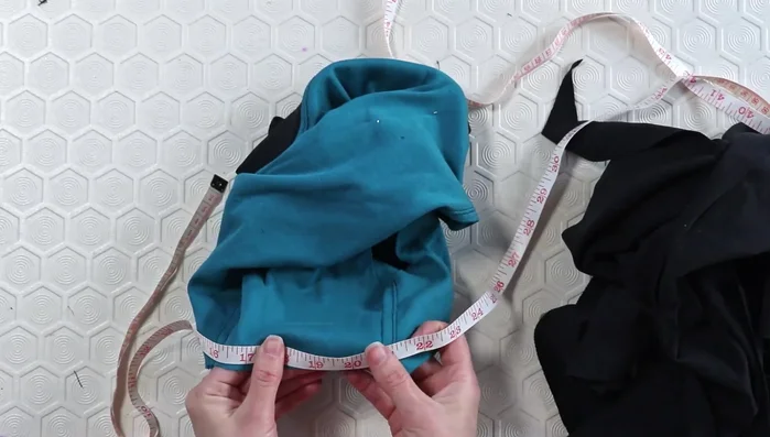 Serge neck binding edges and pin to neckline. Stitch with a single needle (then serge edges again for a cleaner finish, then topstitch with the double needle)