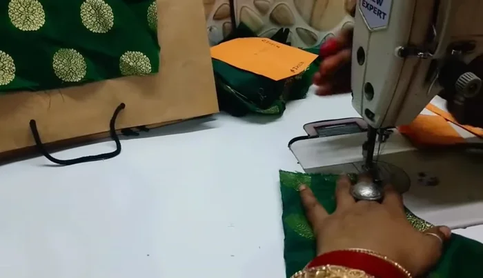 Stitch the seams of the garment pieces together.