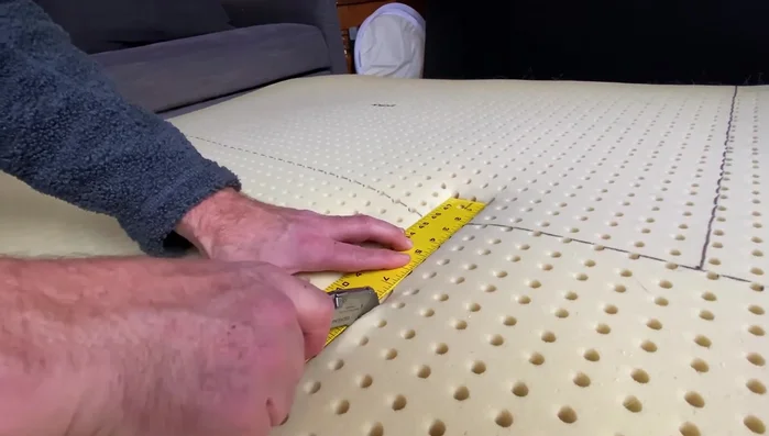 Cut through the mattress layer by layer. The mattress is thick, so it requires multiple passes.