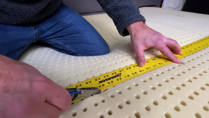 Cut through the mattress layer by layer. The mattress is thick, so it requires multiple passes.