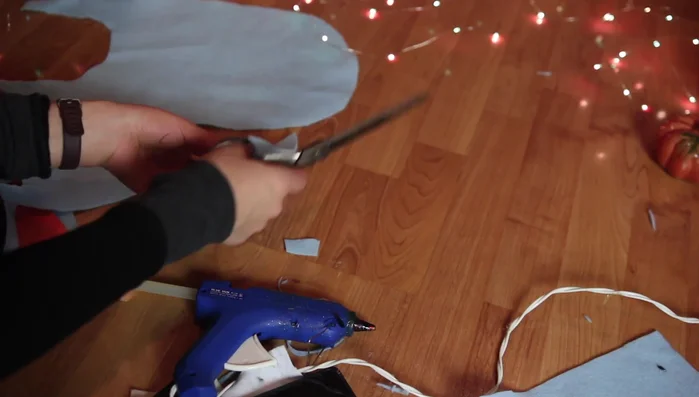 Attach a blue felt tail strip with a pink bow to the bib.