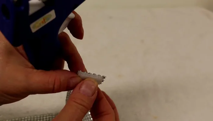 Apply hot glue to the other side of the Velcro and attach it to the other end of the collar, ensuring the collar lies flat. Allow to dry completely.