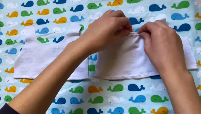 Close sides and sleeves: Sew the side seams of the shirt, attaching sleeves along the bottom seams of the shirt.