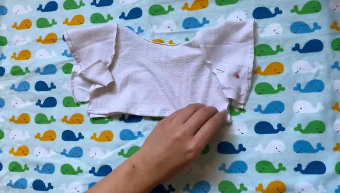 Close sides and sleeves: Sew the side seams of the shirt, attaching sleeves along the bottom seams of the shirt.