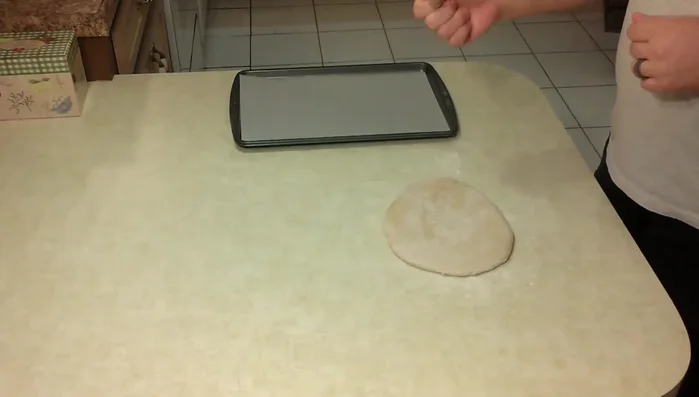 Cut out treats using a treat corer or bottle cap and place them on the cookie sheet.