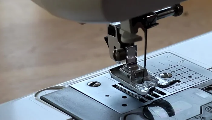 Sew down the fold, close to the zip.