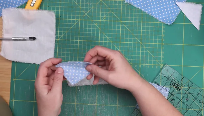 Attach the ears to the cat's head.