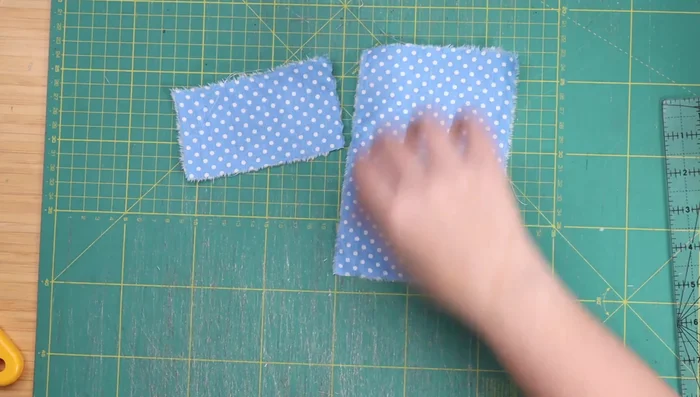 Cut fabric pieces for Cat Quilt Block 2 (four cats): Three patterned rectangles (2.5x4.5 inches, 6.5x4.5 inches, 6.5x3.25 inches) and two white rectangles (6.5x3.25 inches, 1.75x4 inches), and four 2x2 inch squares for ears.