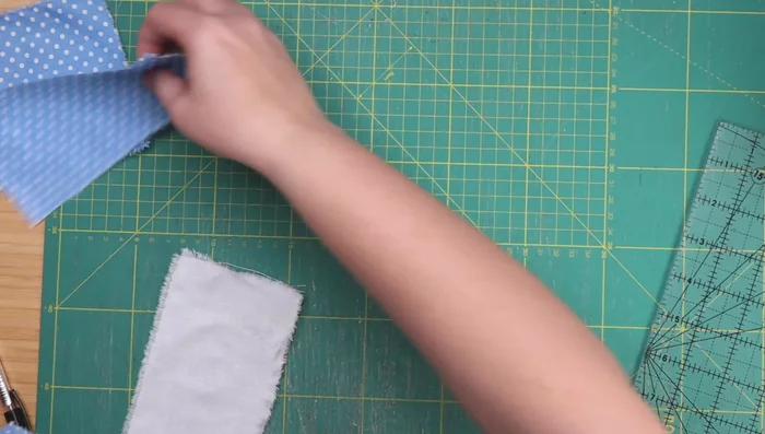 Assemble the cat bodies using the patterned and white rectangles and the ears. Follow the same process as the first block, noting the differences in placement for the lying down cats.