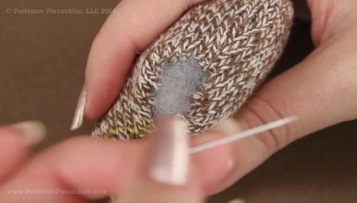 Slip stitch the opening closed using a needle and thread. Start from the underside to hide the knot.