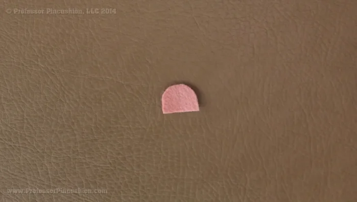 Shape the felt ears into petals by folding in half and sewing a few stitches at the base. Hide the knot on the inside.