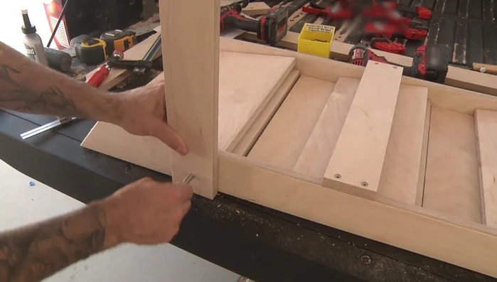 Attach the leg stretcher to the legs.