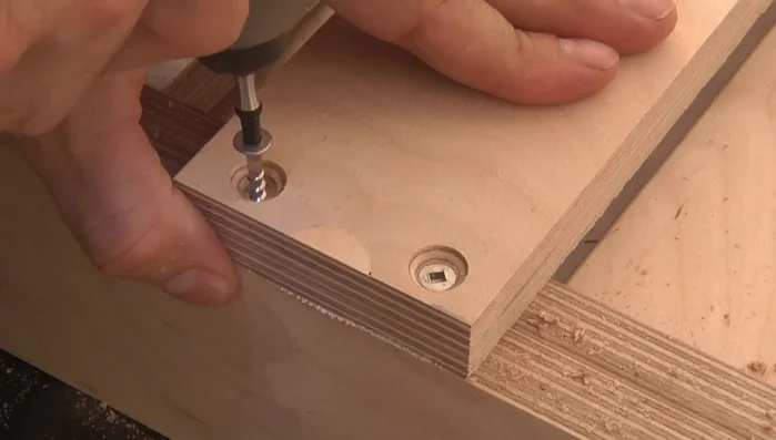 Attach the leg stretcher to the legs.