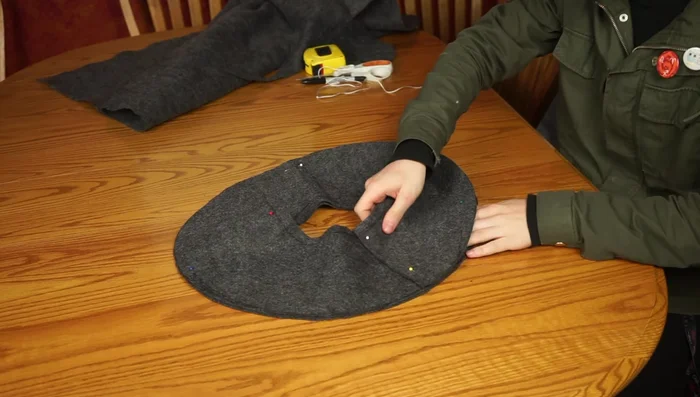 Cut a slice out of the remaining felt to create a slope for the hat brim. Try it on and adjust until it fits snugly.
