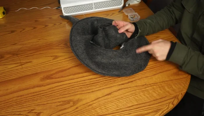 Pin the cone to the brim, matching seams, and sew around the edge to attach the cone to the brim.