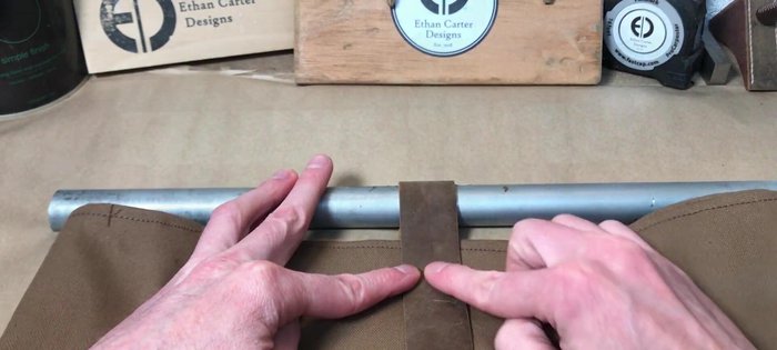 Attach leather loops to the canvas using brass rivets or snaps for connection points to the conduit.