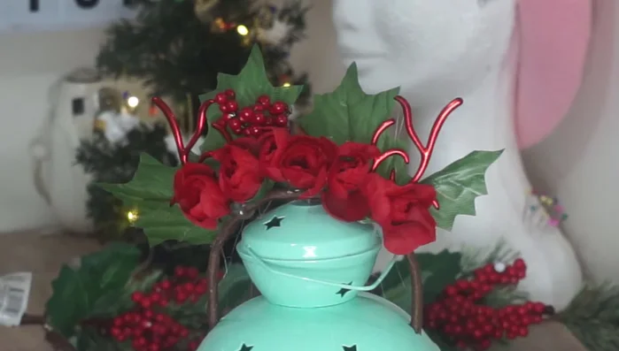 Add decorative elements like berries and white flowers (optional).