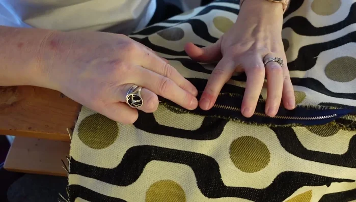 Install the zipper: Press open the seam, lay the zipper face down with teeth over the seam, pin, and sew around the outside of the zipper.