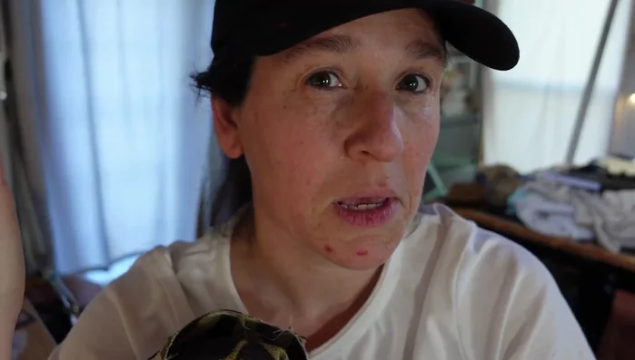 Unpick the center seam to create a hidden zipper. (The video uses thread snips, but a seam ripper or X-Acto knife is also shown as an option.)