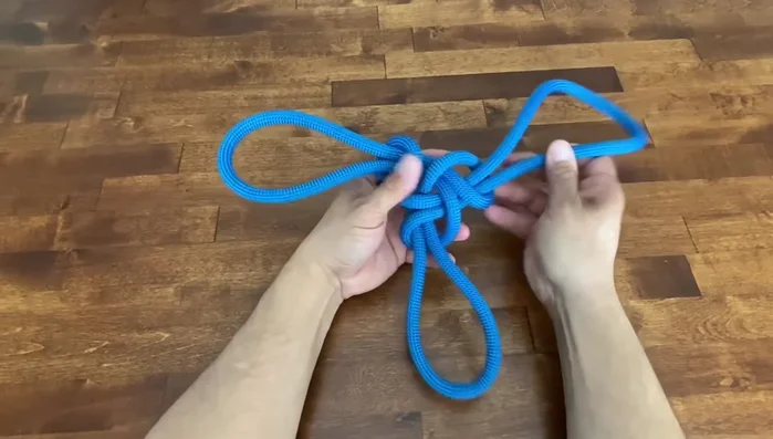 Adjust the knot and pull it tight. Ensure the seam is on the inside.