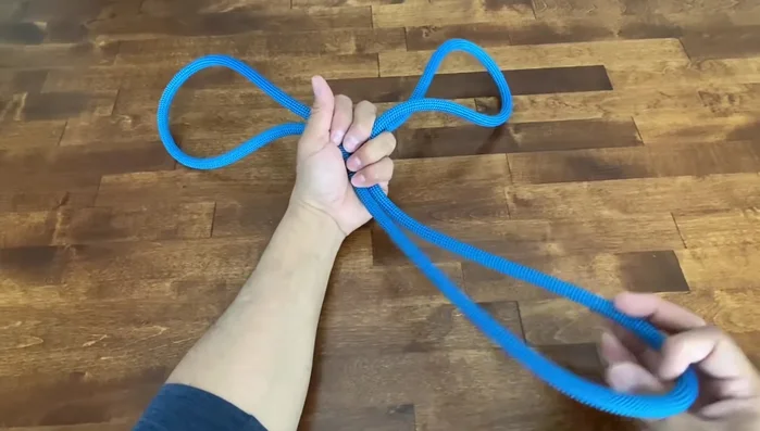 Adjust the knot and pull it tight. Ensure the seam is on the inside.