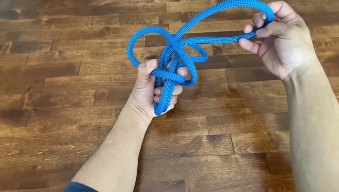 Adjust the knot and pull it tight. Ensure the seam is on the inside.