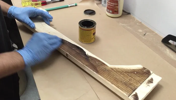 Sand off some of the stain with a random orbital sander and use a steel brush to texture the wood for a weathered look. Apply a Golden Oak stain for a two-toned effect.