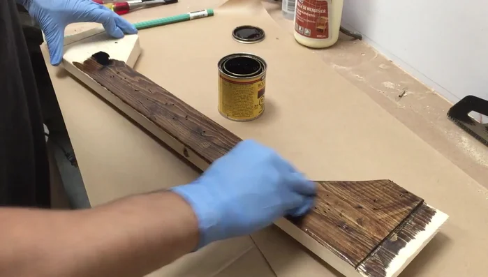 Sand off some of the stain with a random orbital sander and use a steel brush to texture the wood for a weathered look. Apply a Golden Oak stain for a two-toned effect.