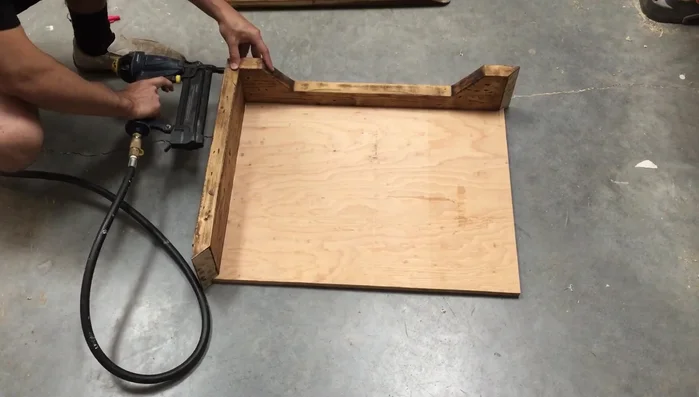 Assemble the four side pieces to the plywood base using glue and brad nails.