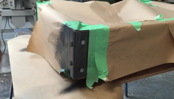 Tape off the corners and spray them with hammered black spray paint.