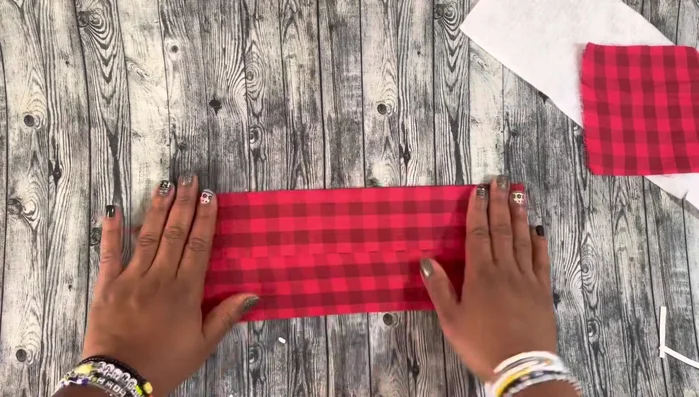 Fold and iron again: Create another crease by folding and ironing the fabric.