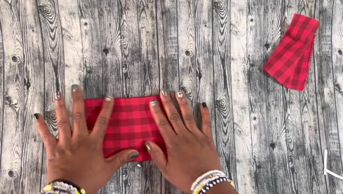 Fold and iron again: Create another crease by folding and ironing the fabric.