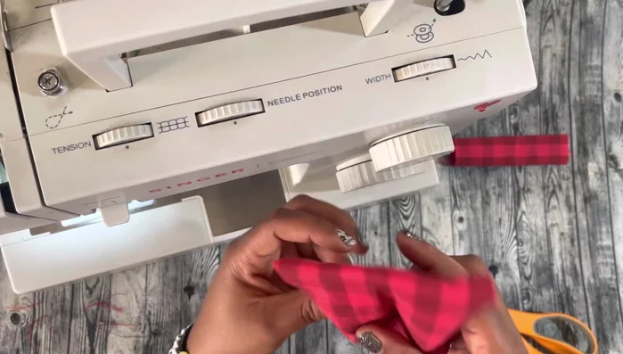 Add hot glue (optional): Apply hot glue to the center to prevent the small bow piece from sliding.