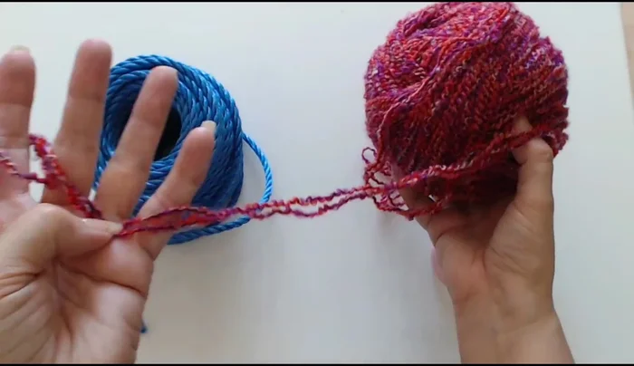 Join two strands of yarn together.